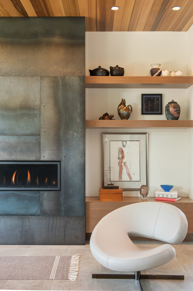 Photo of a mid-sized contemporary living room in Other with a metal fireplace surround, beige walls, a ribbon fireplace and beige floor.