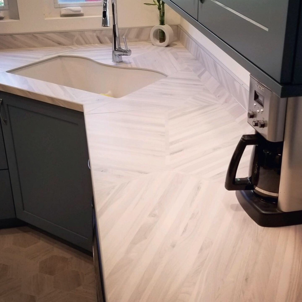Inspiration for a large transitional l-shaped dark wood floor and brown floor enclosed kitchen remodel in Boise with shaker cabinets, green cabinets, granite countertops, brown backsplash, stone tile backsplash, paneled appliances, a peninsula and brown countertops