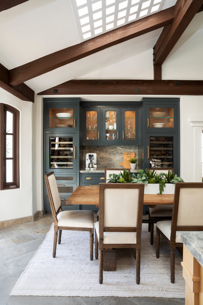 Inspiration for a large mediterranean kitchen/diner in Orange County with an integrated sink, recessed-panel cabinets, light wood cabinets, quartz worktops, white splashback, ceramic splashback, stainless steel appliances, limestone flooring, an island, grey floors, green worktops and exposed beams.