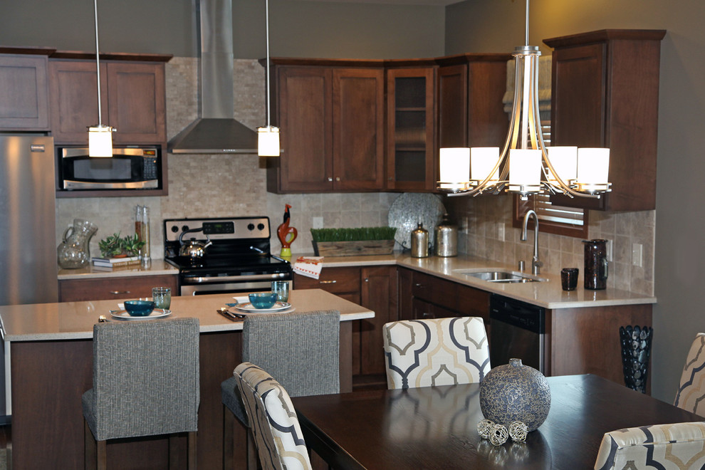 Example of a mid-sized transitional l-shaped dark wood floor open concept kitchen design with an undermount sink, recessed-panel cabinets, dark wood cabinets, quartz countertops, beige backsplash, ceramic backsplash, stainless steel appliances, gray walls and an island