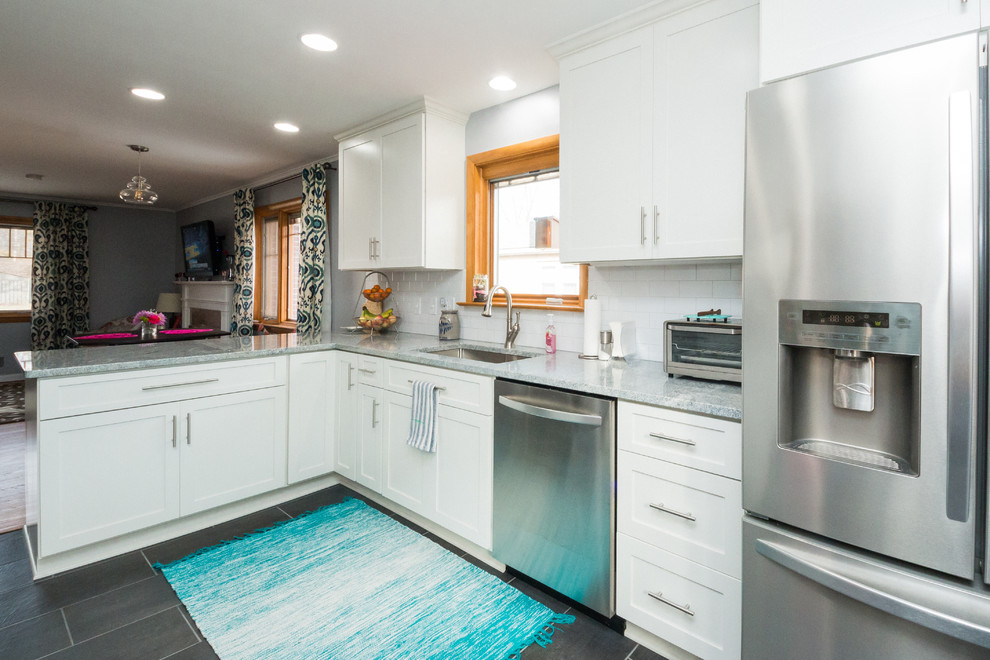Inspiration for a mid-sized transitional l-shaped eat-in kitchen remodel in Columbus with an undermount sink, shaker cabinets, white cabinets, granite countertops, white backsplash, subway tile backsplash and stainless steel appliances