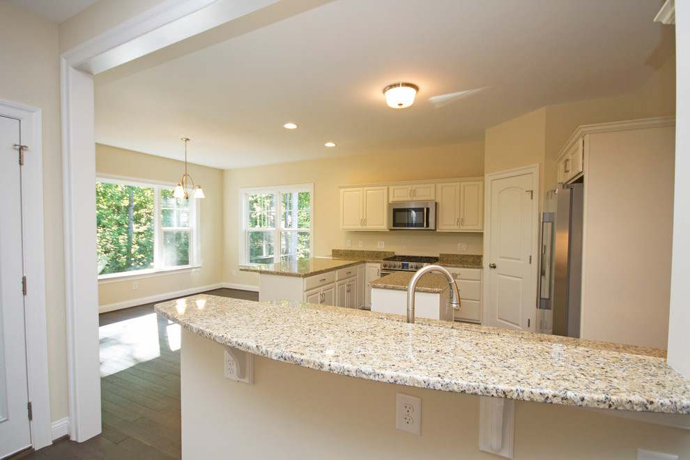 Large transitional u-shaped dark wood floor eat-in kitchen photo in Richmond with raised-panel cabinets, white cabinets, granite countertops, beige backsplash, stainless steel appliances and an island