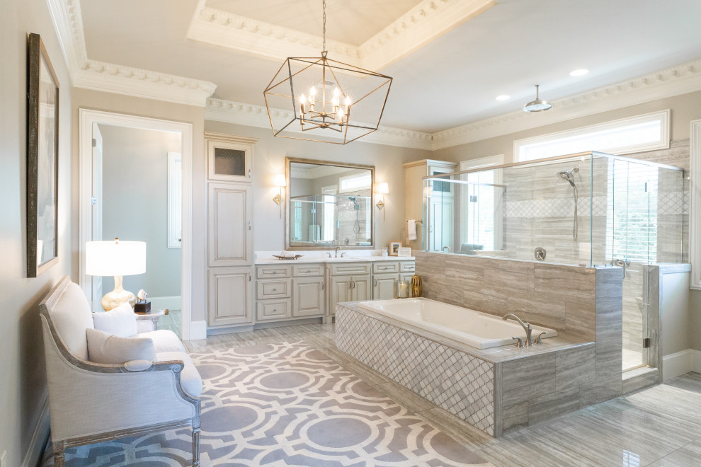 Inspiration for a traditional master bathroom in Birmingham with raised-panel cabinets, grey cabinets, a drop-in tub, gray tile, grey walls, an undermount sink, grey floor and white benchtops.