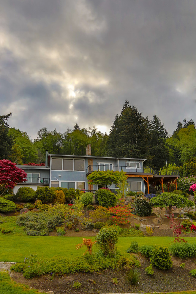Large beach style side yard deck photo in Seattle