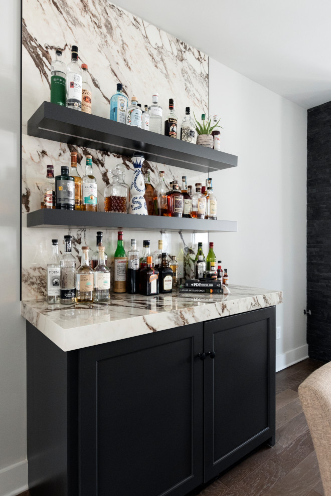 Design ideas for a small contemporary single-wall dry bar in Nashville with recessed-panel cabinets, grey cabinets, white splashback, porcelain splashback, medium hardwood flooring, brown floors and white worktops.
