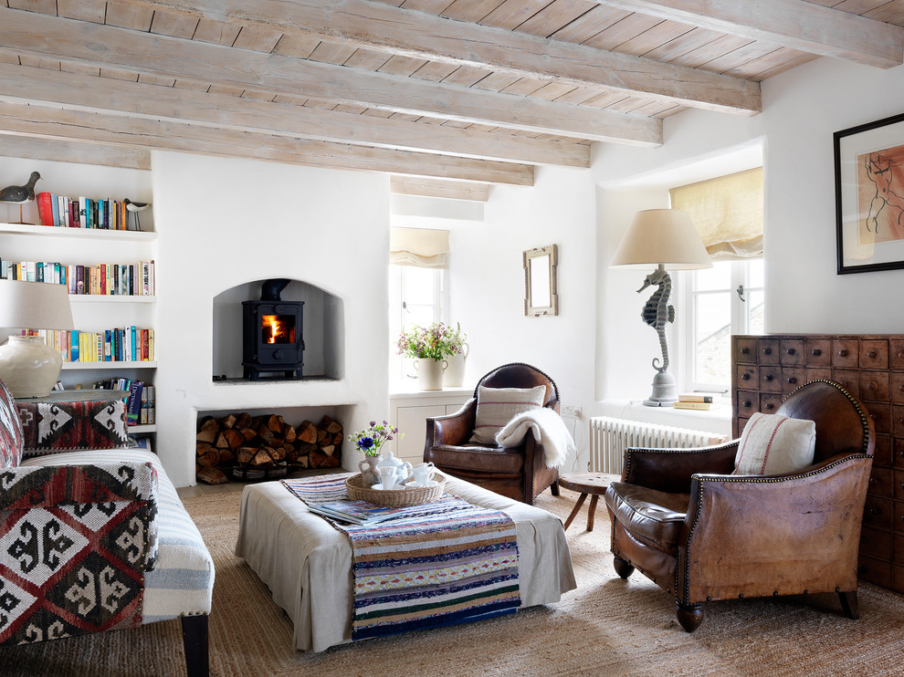 Inspiration for a large country open concept living room in London with white walls and a wood stove.