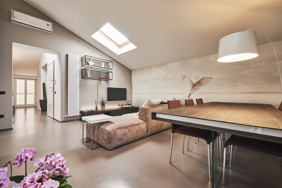 This is an example of a large contemporary formal open concept living room in Florence with beige walls, concrete floors, a wall-mounted tv and grey floor.