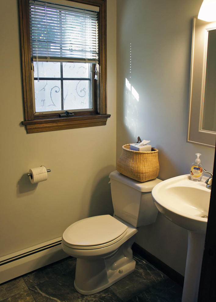This is an example of a small transitional 3/4 bathroom in Bridgeport with a two-piece toilet, green walls, ceramic floors, a pedestal sink and grey floor.