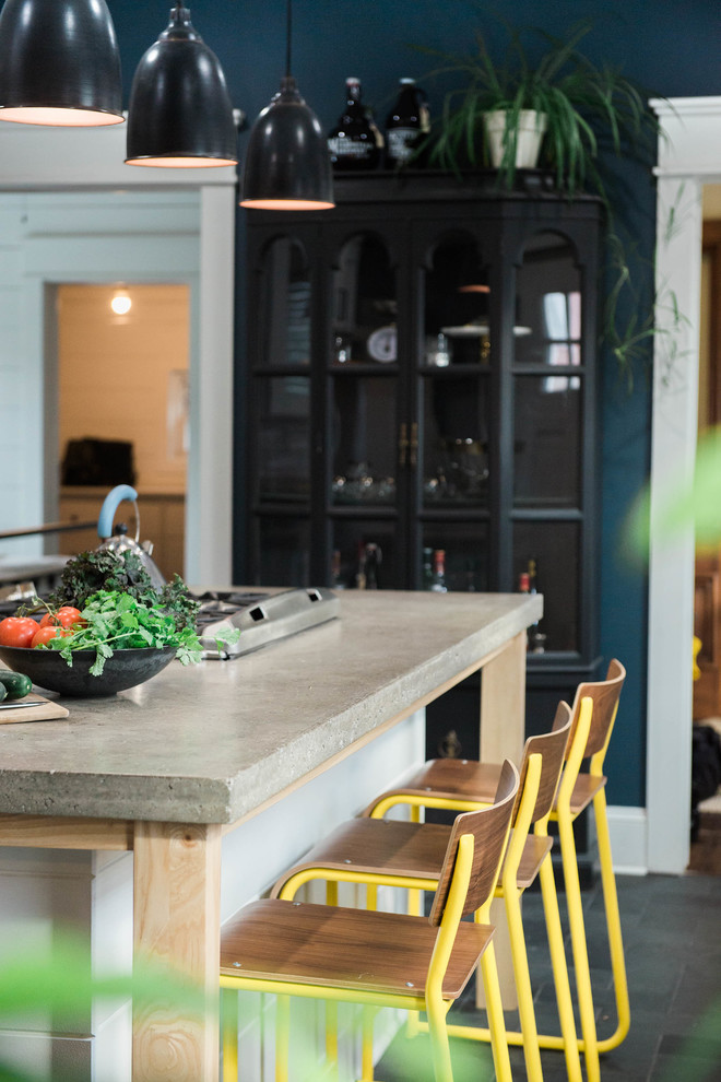 Kitchen pantry - small eclectic single-wall slate floor and gray floor kitchen pantry idea in New York with an undermount sink, glass-front cabinets, white cabinets, concrete countertops, white backsplash, ceramic backsplash, stainless steel appliances and an island