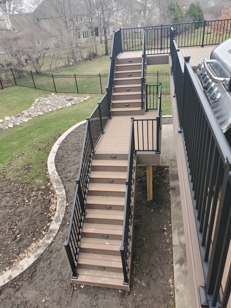 Inspiration for a large backyard second story metal railing deck remodel with no cover