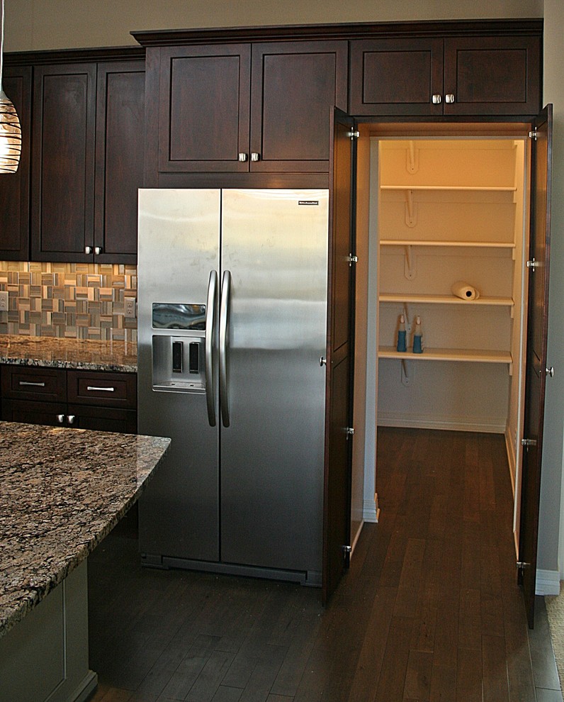 Design ideas for a traditional open plan kitchen in Omaha with recessed-panel cabinets.