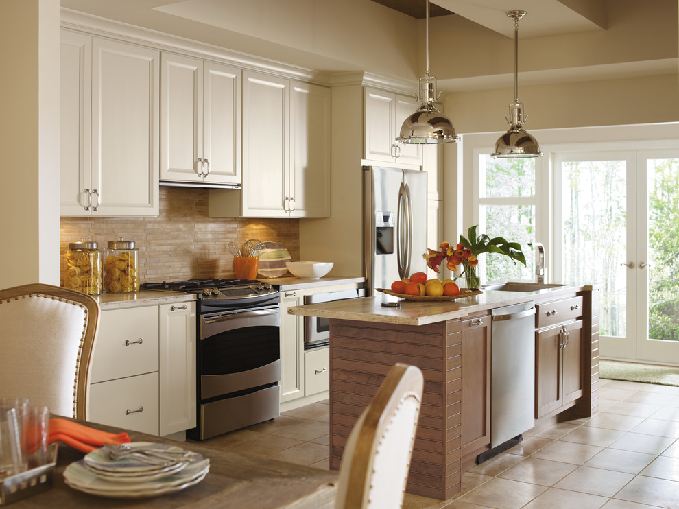Inspiration for a small transitional single-wall travertine floor open concept kitchen remodel in Toronto with an undermount sink, recessed-panel cabinets, white cabinets, granite countertops, beige backsplash, stone tile backsplash, stainless steel appliances and an island