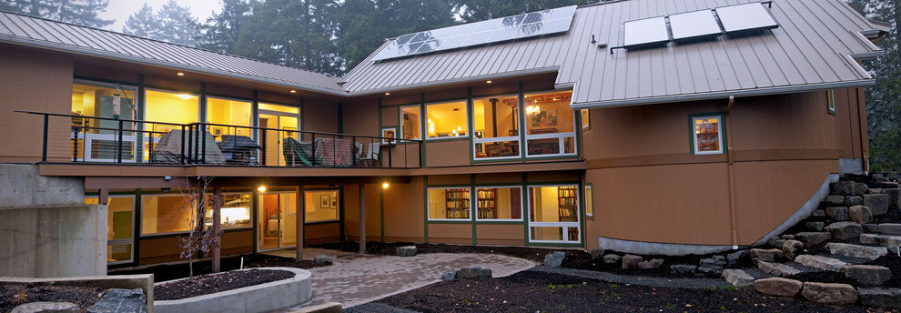 Design ideas for a contemporary two-storey exterior in Other with a metal roof.