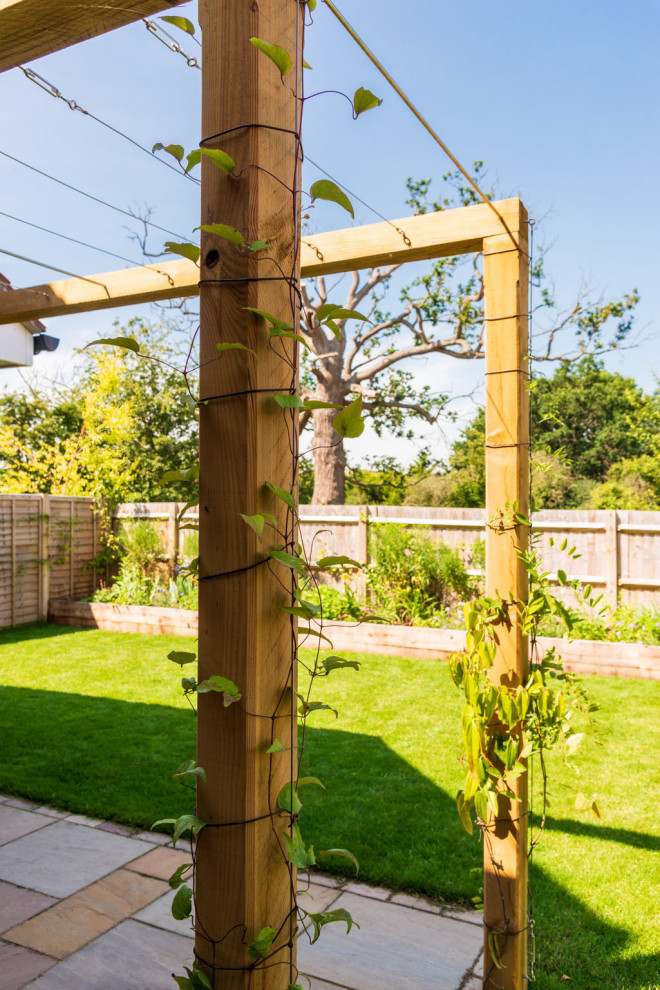 Idee per un piccolo giardino country esposto a mezz'ombra dietro casa con pavimentazioni in pietra naturale e recinzione in legno