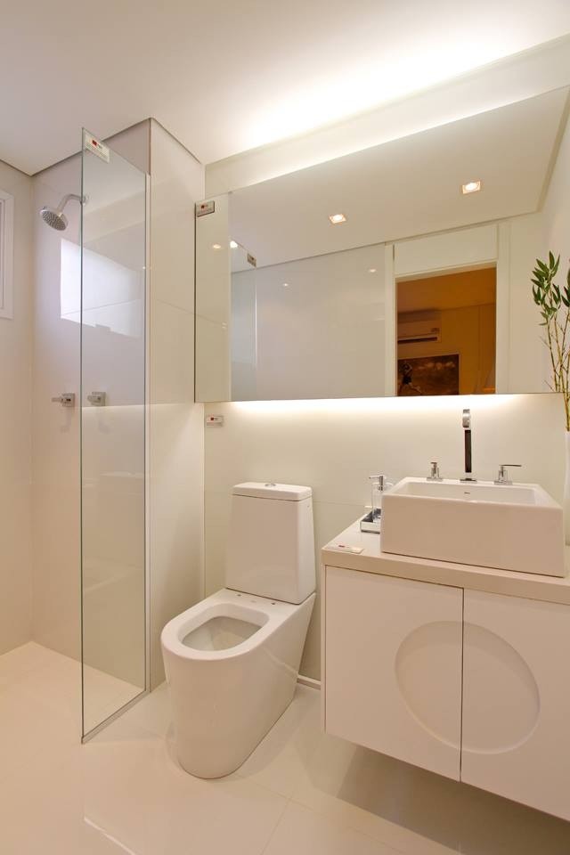 This is an example of a mid-sized asian master bathroom in Miami with shaker cabinets, white cabinets, an open shower, a two-piece toilet, white tile, ceramic tile, white walls, ceramic floors, a vessel sink and solid surface benchtops.