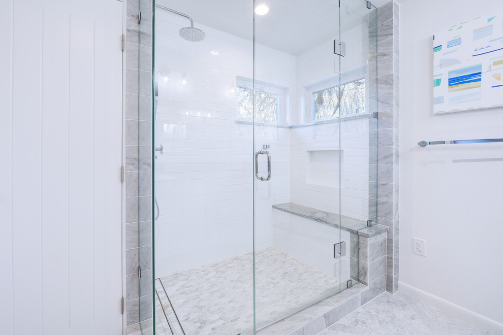 Design ideas for a mid-sized transitional master bathroom in Denver with white cabinets, white tile, marble floors, a hinged shower door, recessed-panel cabinets, a corner shower, a one-piece toilet, marble, white walls, an undermount sink, limestone benchtops, white floor and grey benchtops.