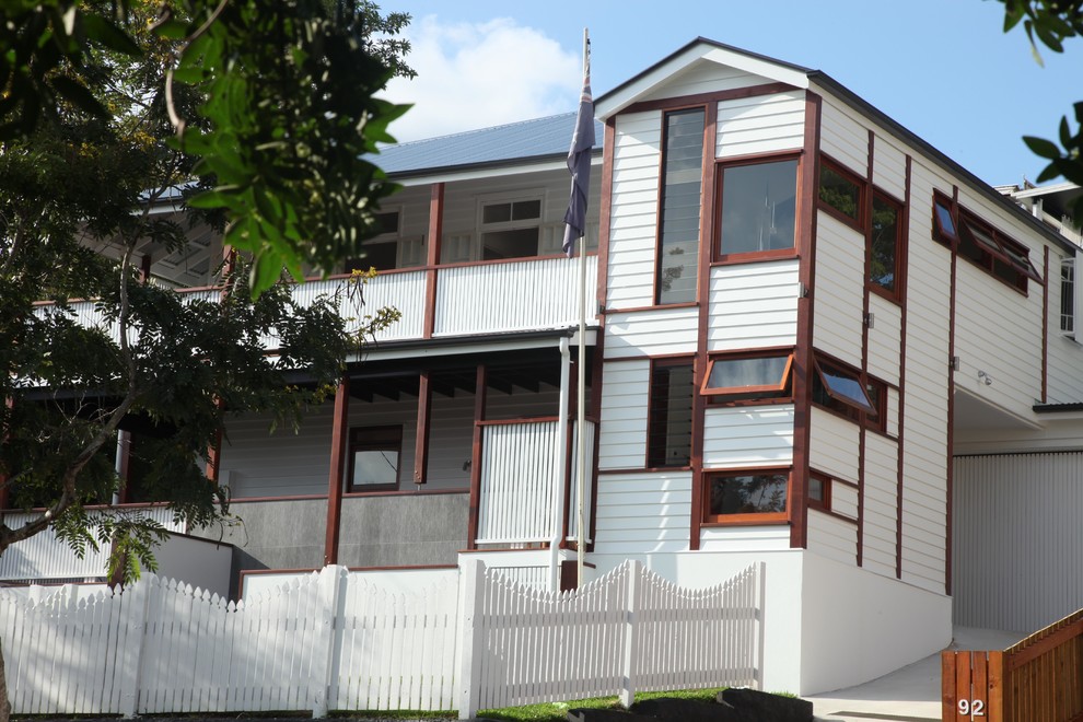 This is an example of a large traditional two-storey white exterior in Brisbane with wood siding.