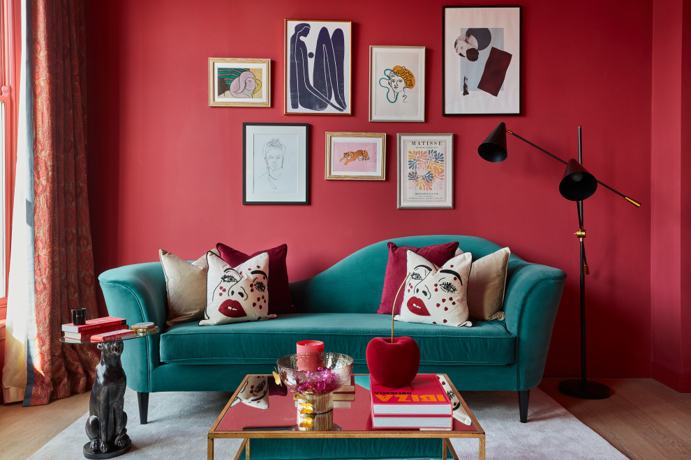 Mid-sized eclectic medium tone wood floor living room library photo in London with pink walls and a wall-mounted tv