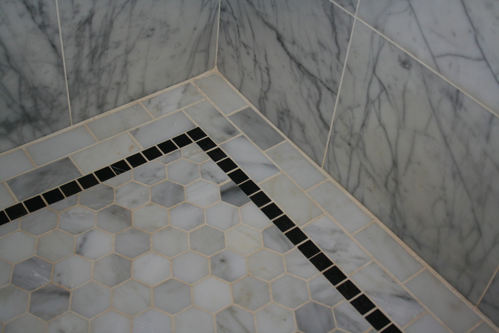 Photo of a large traditional master bathroom in Providence with shaker cabinets, white cabinets, marble benchtops, gray tile, porcelain tile, an alcove shower, a two-piece toilet, an undermount sink, grey walls and marble floors.