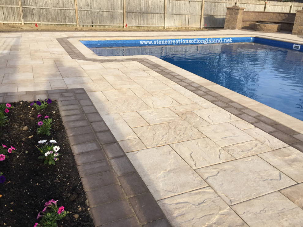 Inspiration for a large modern backyard rectangular lap pool in New York with a water feature and concrete pavers.
