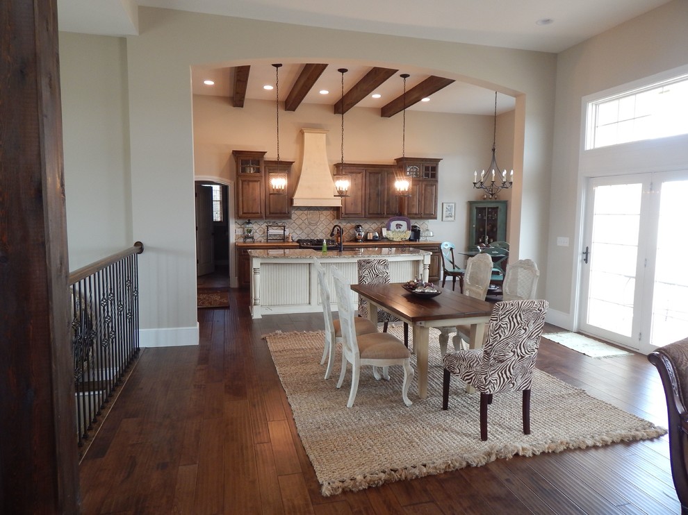 Design ideas for a mid-sized country open plan dining in Other with beige walls, dark hardwood floors, no fireplace and brown floor.
