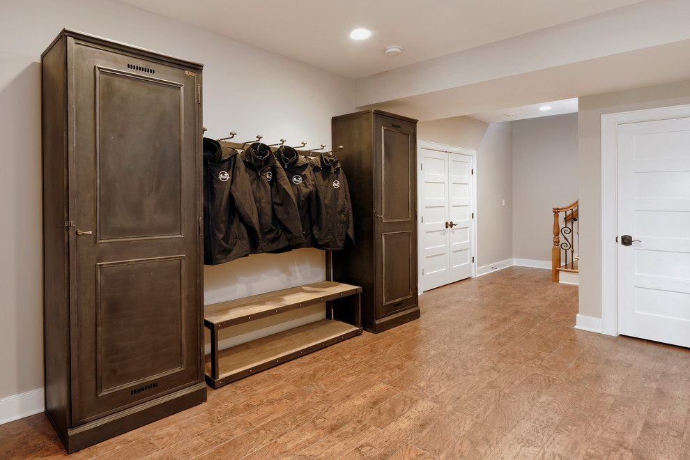 Example of a large transitional light wood floor and beige floor mudroom design in DC Metro with beige walls and a white front door