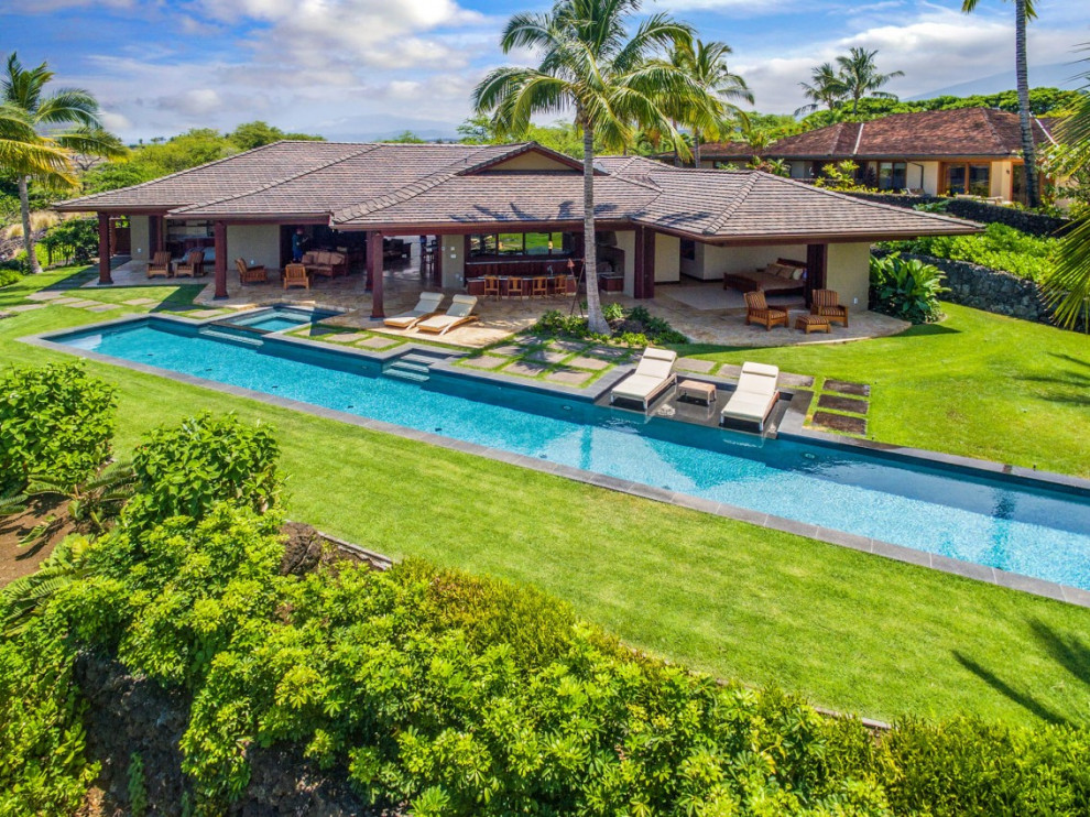 Pool landscaping - large craftsman backyard stone and rectangular lap pool landscaping idea in Hawaii