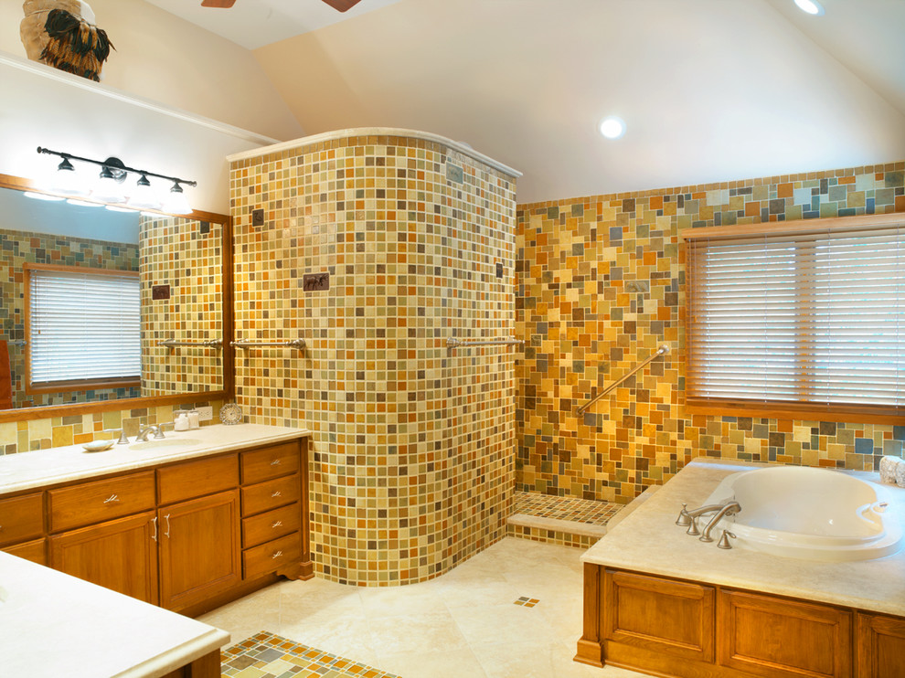 This is an example of a traditional bathroom in Columbus with recessed-panel cabinets, medium wood cabinets, an open shower, multi-coloured tile, multi-coloured walls, a drop-in tub and an open shower.