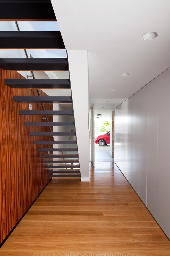 Inspiration for a modern straight staircase in Sydney with open risers.