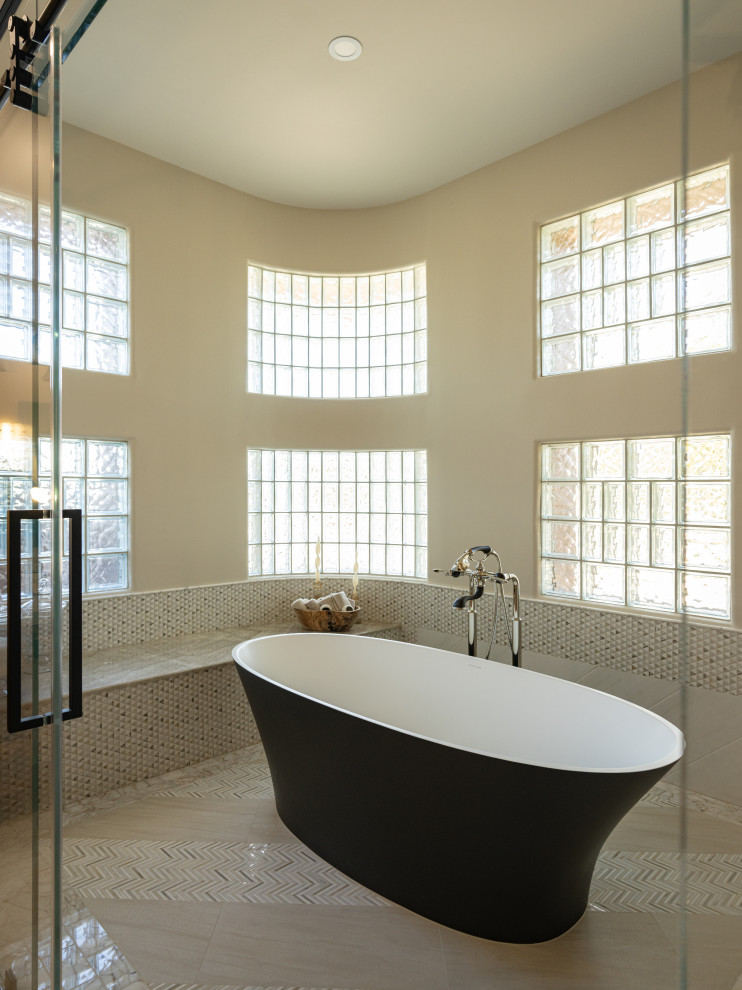 Freestanding bathtub - large transitional freestanding bathtub idea in Phoenix with beige walls