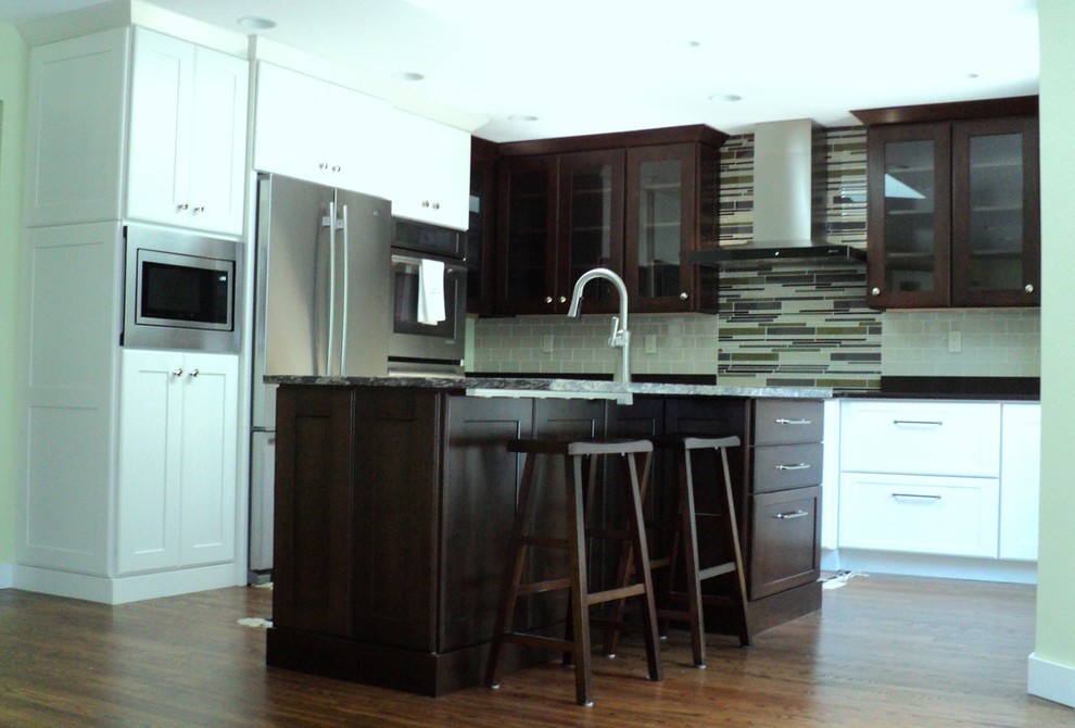 Large transitional l-shaped dark wood floor open concept kitchen photo in Bridgeport with a farmhouse sink, shaker cabinets, white cabinets, quartzite countertops, beige backsplash, glass tile backsplash, stainless steel appliances and an island