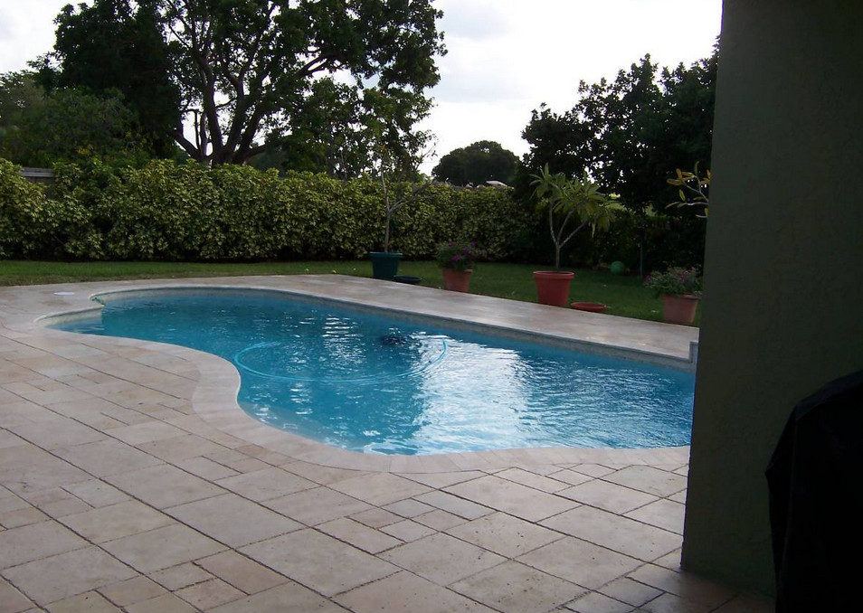 Hot tub - transitional backyard tile and custom-shaped natural hot tub idea in Miami
