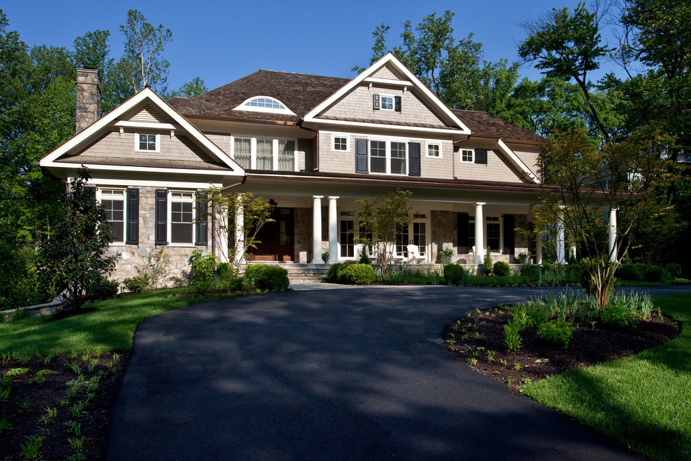 This is an example of a traditional exterior in DC Metro with stone veneer and a shingle roof.