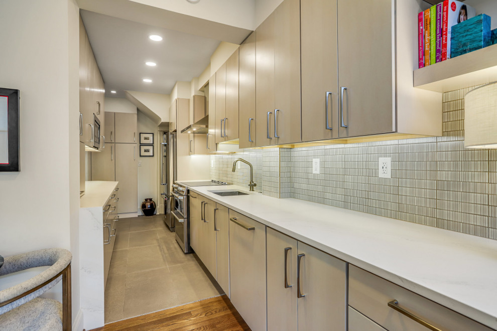 Mid-sized transitional galley kitchen pantry photo in DC Metro with a drop-in sink, flat-panel cabinets, light wood cabinets, stainless steel appliances and no island