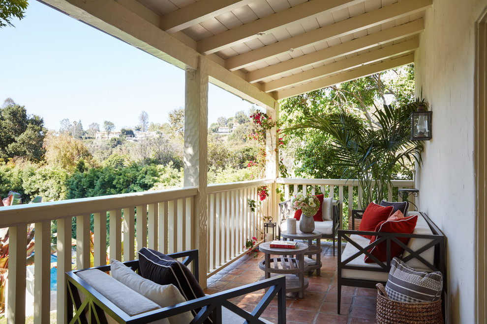 Small mediterranean backyard verandah in Los Angeles with tile and a roof extension.