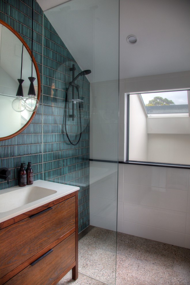 Contemporary bathroom in Sydney with medium wood cabinets, a curbless shower, green tile, white tile, mosaic tile, white walls, a console sink, beige floor, an open shower and flat-panel cabinets.