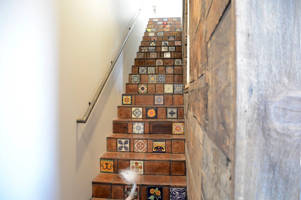 Inspiration for a mid-sized tile straight staircase in Other.