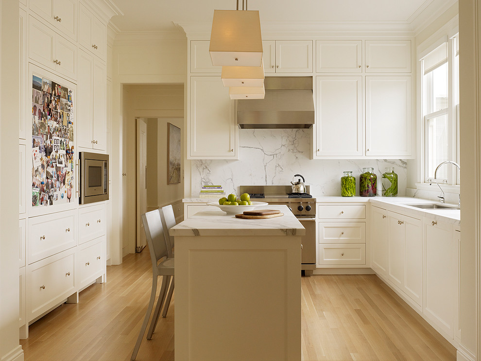 Photo of a traditional kitchen in San Francisco with stainless steel appliances and marble splashback.