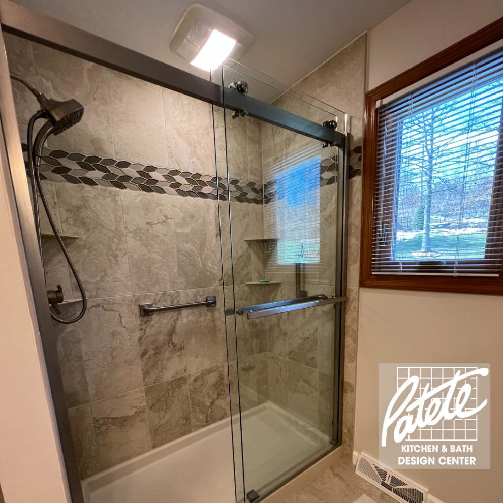 Photo of a traditional bathroom in Other with an alcove shower, beige tile, ceramic tile, beige walls, wood-look tile, beige floor, a hinged shower door and a niche.