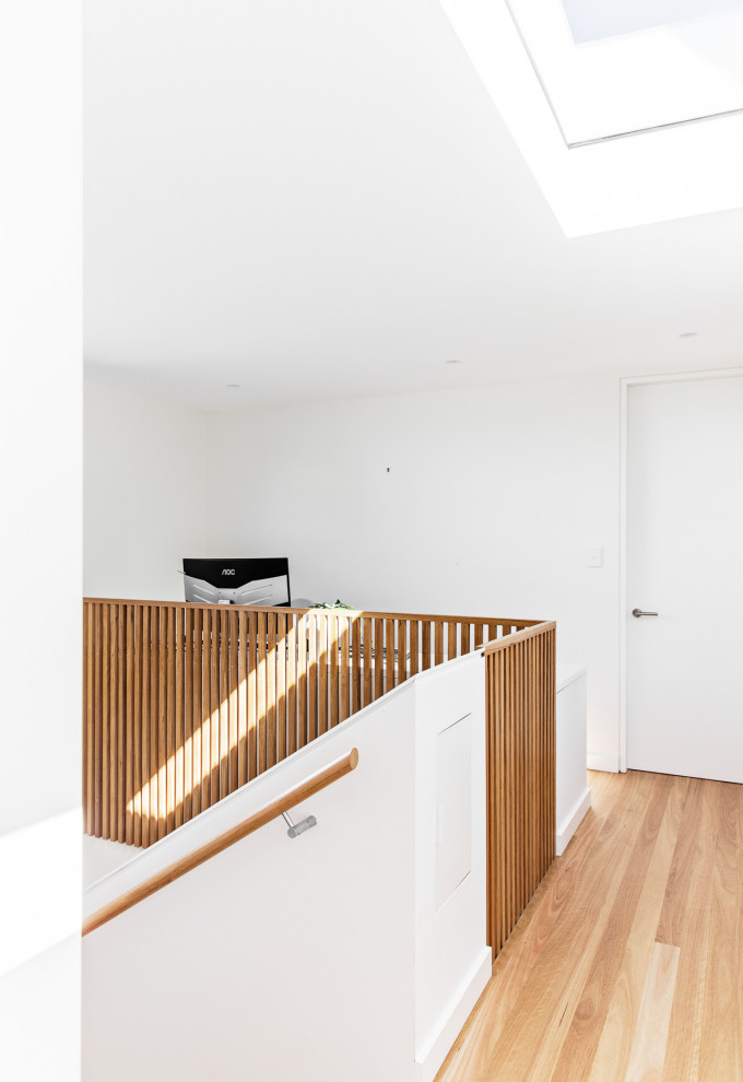 Design ideas for a mid-sized contemporary wood u-shaped staircase in Sydney with wood risers and wood railing.