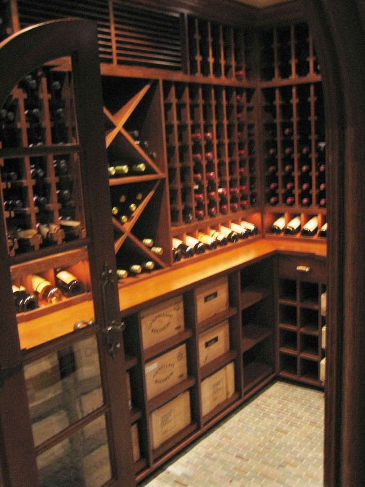 Mid-sized traditional wine cellar in Bridgeport with ceramic floors, storage racks and grey floor.