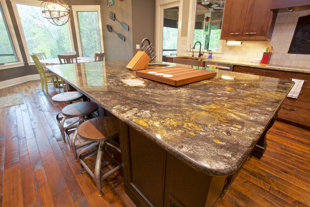 Example of a large transitional l-shaped medium tone wood floor open concept kitchen design with a farmhouse sink, shaker cabinets, medium tone wood cabinets, marble countertops, beige backsplash, ceramic backsplash, colored appliances and an island