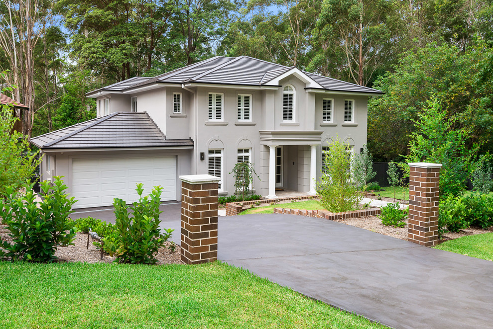 Inspiration for a large contemporary two-storey stucco grey exterior in Sydney with a hip roof.