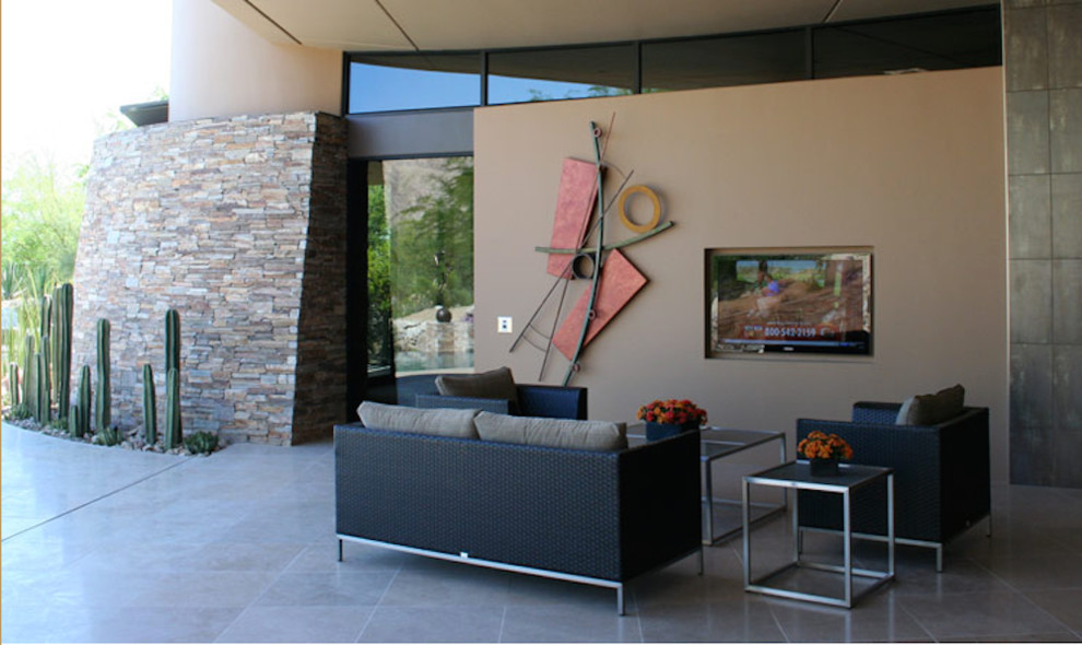 Design ideas for a large contemporary patio in Los Angeles with tile and a roof extension.