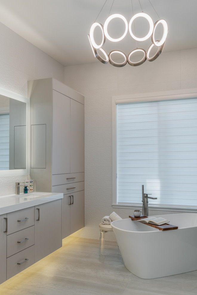 Mid-sized transitional master gray tile and porcelain tile porcelain tile, gray floor and double-sink bathroom photo in Tampa with flat-panel cabinets, gray cabinets, a one-piece toilet, gray walls, an undermount sink, quartz countertops, white countertops, a niche and a floating vanity