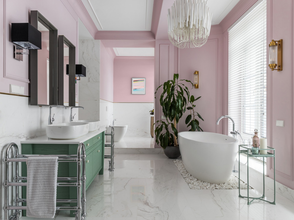 Inspiration for a contemporary master bathroom in Other with green cabinets, a freestanding tub, white tile, pink walls, a vessel sink, white floor, white benchtops, an enclosed toilet, a double vanity, a freestanding vanity and recessed.