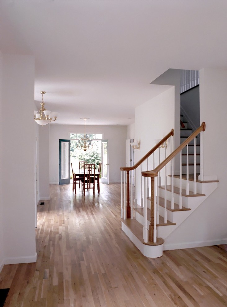 Inspiration for a mid-sized coastal brown floor hallway remodel in Boston with white walls