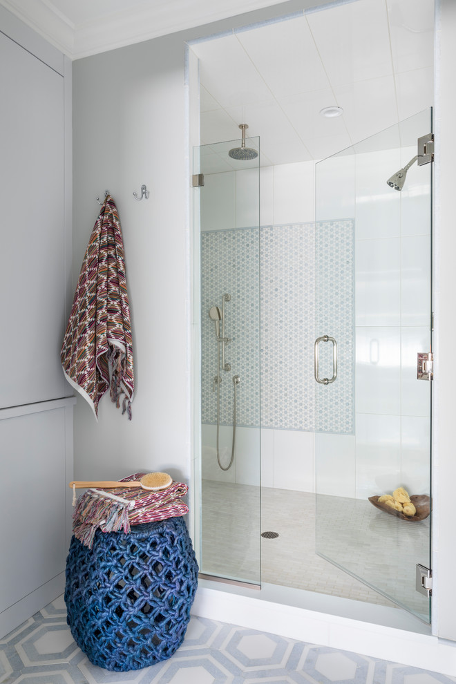 Transitional bathroom in New York with an alcove shower, white tile, grey walls, multi-coloured floor and a hinged shower door.