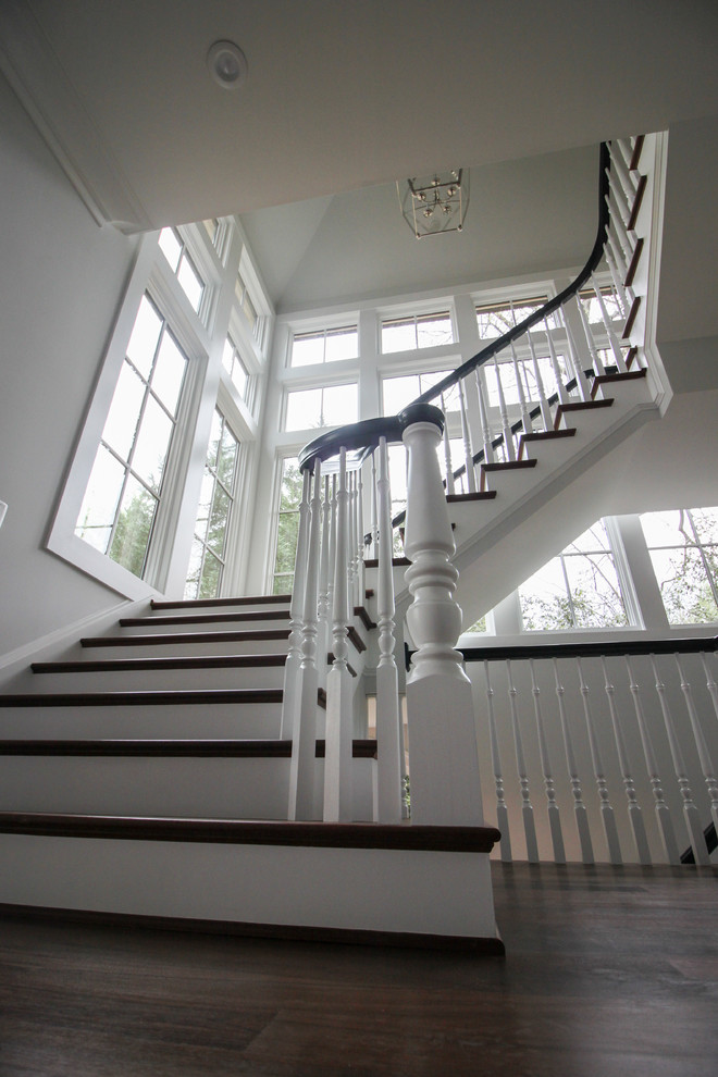Large transitional wooden floating wood railing staircase photo in DC Metro with wooden risers