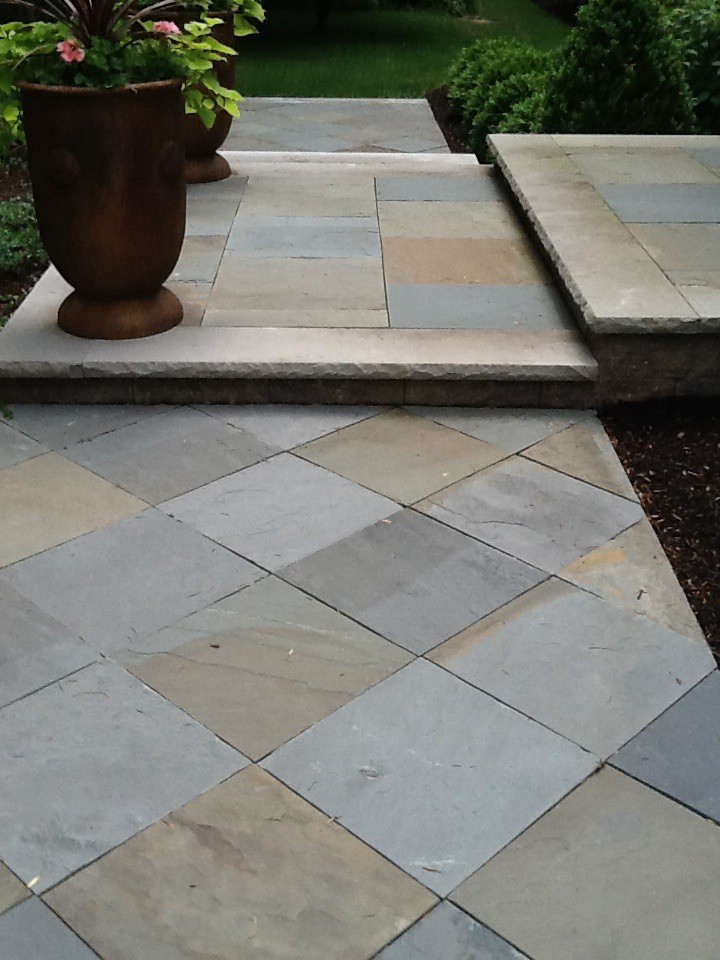 This is an example of a mid-sized traditional front yard formal garden in Philadelphia with a garden path and concrete pavers.